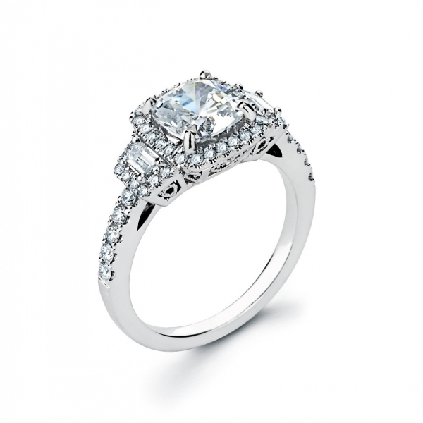 Halo style three stone diamond engagement ring in white gold